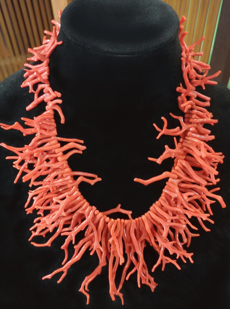 A striking necklace in Croatian coral, two strands of longer coral pieces at the front, shorter pieces on one strand at the back for a good fit.