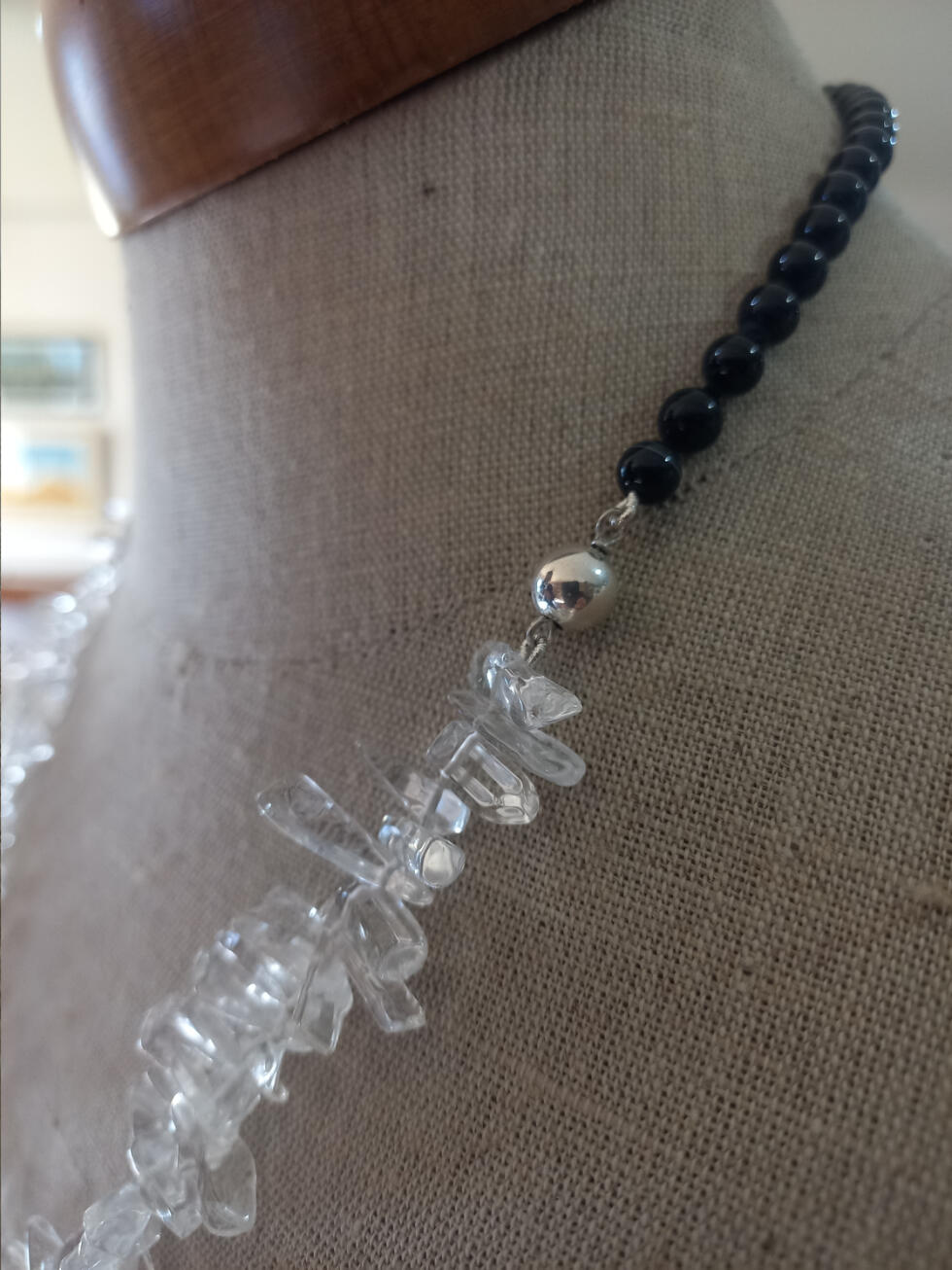 Clear quartz and black onyx necklace with a sterling silver bead as a joiner, matching the magnet clip on the other side. Necklace with a front of clear quartz pieces, rear in round black onyx beads, with a sterling silver bead as a joiner, matching the magnet clip on the other side.